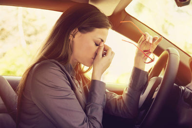 Woman in car uncomfortable because she does not have eyeglasses glare protection