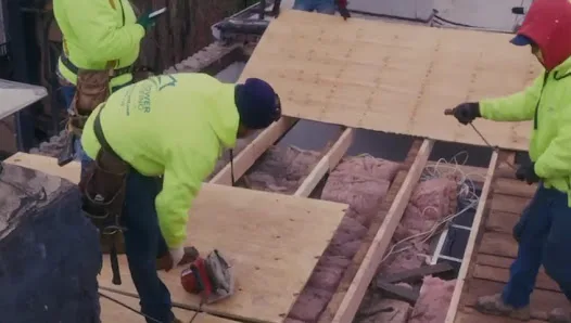 Close-up of roofing materials and flashing details during an inspection